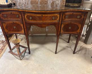Banded mahogany serpentine sideboard with glass top