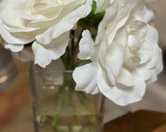 Faux flowers in glass vase