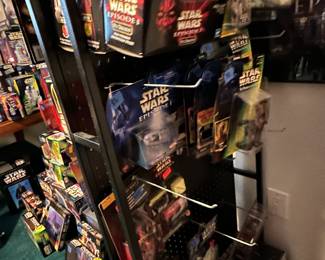 Display stand full of Star Wars toys in original boxes