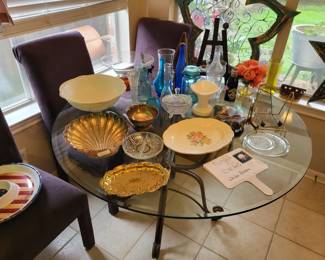 glass kitchen table with vintage items and 4 matching chairs