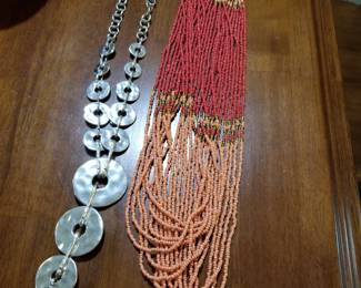Costume jewelry includes coral necklace and Chico's silver circles.