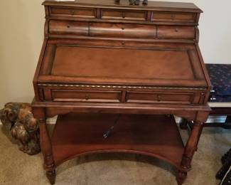 Fold down desk with rounded drawers and plug for laptop or electronics.