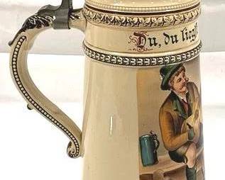 2088 - Vintage German Beer Stein w/ lid 14.5" tall - 1/2L - features a man seated with a pipe and the inscription "du, du lig" may translate to "you, you lie"