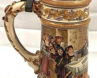2093 - Vintage German Beer Stein w/ lid 15.5" tall - features a banquet scene and the phrase "Wein, Eib und Gesang," which translates to "Wine, women and song".