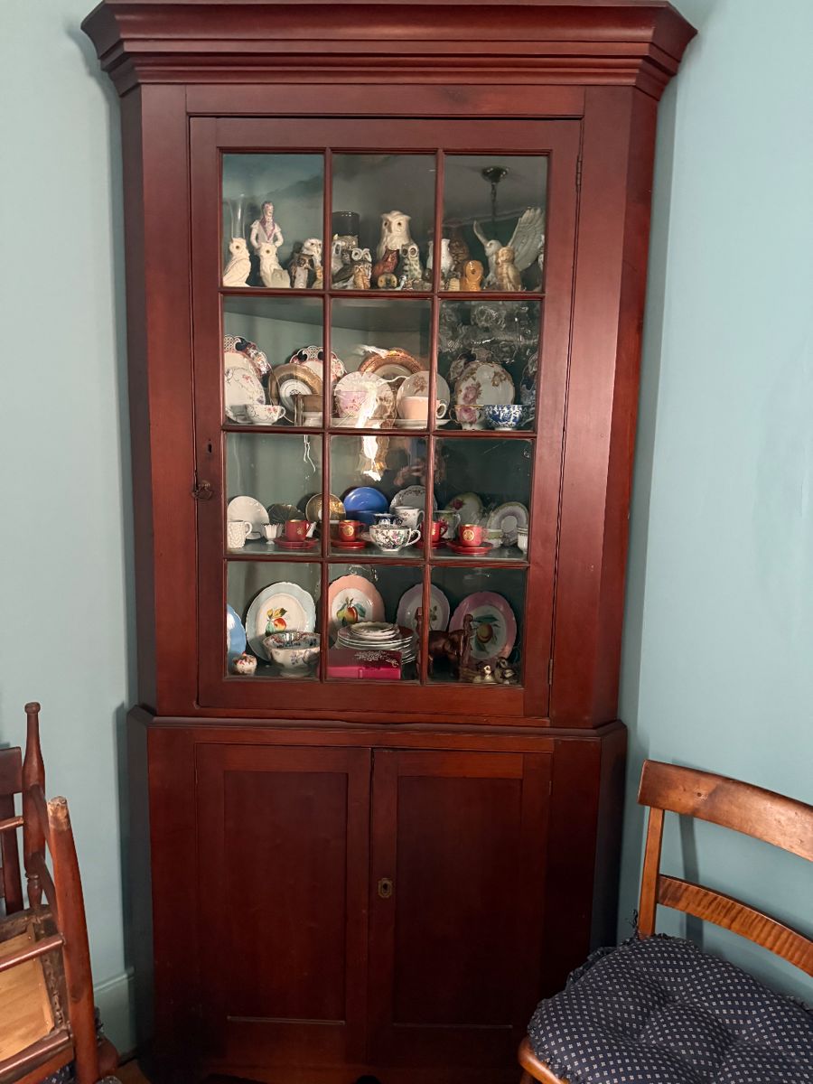 Exceptional original surface 19th century cherry corner cupboard. Two sections, just over 7 ft. height. Cupboard is loaded with owl and tea cup/saucer collections, etc.