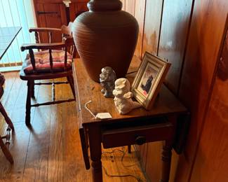 A sweet small one drawer drop leaf table.  Pottery lamp.