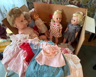Box lot of vintage dolls and clothes.