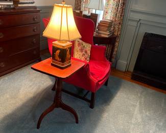 Early Cherry candlestand and one of two matching wing back chairs of Centennial era.  Lamp is a repurposed advertising tea tin.