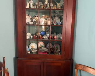 Exceptional original surface 19th century cherry corner cupboard. Two sections, just over 7 ft. height. Cupboard is loaded with owl and tea cup/saucer collections, etc.