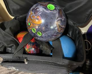 Three bowling balls and not pictured a million vintage bowling trophies