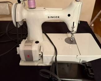 Here’s your chance to own a beautiful White Singer Featherweight 221K, one of the most sought-after vintage sewing machines ever made. This model was manufactured in 1960 in Clydebank, Scotland and is known for its lightweight design, exceptional stitch quality, and long-lasting performance.

This particular machine is the rare white (pale celery green) version, produced in much smaller numbers than the traditional black models. It's highly prized by collectors and quilters alike for both its performance and vintage charm.