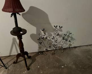 Old solar lamp on wood stand next to a wall candle holder