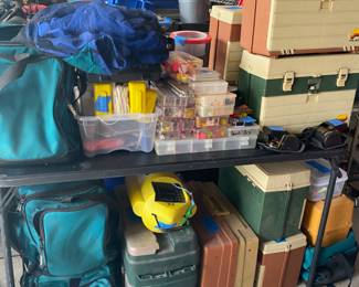 Tackle boxes; boxes of fishing flies; boxes of rubber worms; rain gear; other fishing accessories