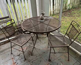 wrought iron table and 3 chairs