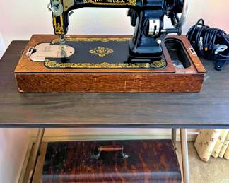 Antique White Rotary sewing machine with tiger oak cabinet; runs.