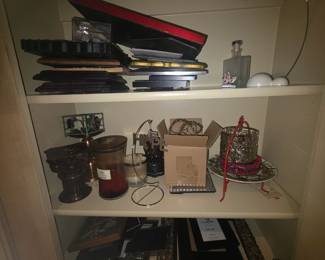 Items in shelves: Top = various frames in numerous sizes, bottle & ornament holder; 2nd shelf = Candles, “HOPE” holder, plate, & miscellaneous; 3rd shelf = various size frames