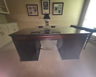 Large wooden desk with glass top