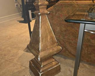 Large pyramid shaped decor behind sofa