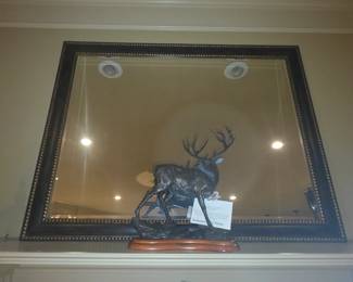 Metal elk statue in front of Mantle mirror