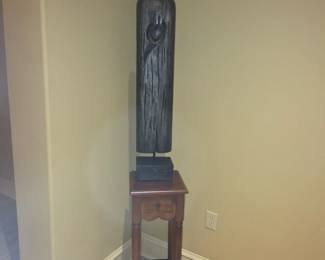 Small table with dark metal statue