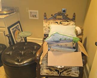 Chair on right with large assortment of throw pillows in various designs & colors