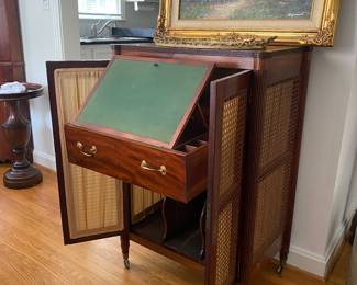 Cabinet with cane doors and pull-out writing/art easel.