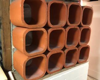 Red clay chimney flue liners (12”x12”x12”) Were used as a wine rack - they’re just stacked on top of each other