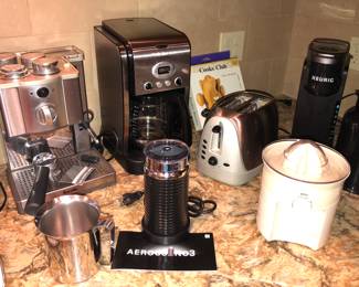 Breville Cafe Roma espresso maker, Cuisinart Extreme Brew coffee maker, Nespresso Aeroccino3 milk frother, Oster toaster, Braun citrus juicer