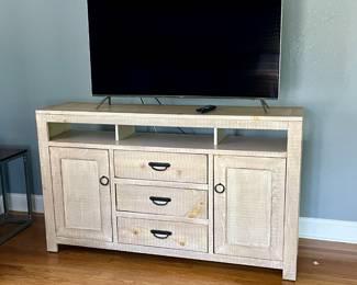 South Creek 66" Console. Excellent condition! It is 66" long and accommodates up to a 70" flat screen TV. Triple drawers and an adjustable shelf behind each door. Also pictured is a Samsung 55” Model UN55KS8500F TV