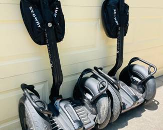 Two SEGWAY PT i2 model with handlebar bag included.