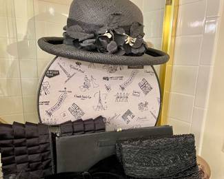 Black purses, hat and hat box