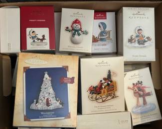 Dozens of boxed Hallmark ornaments.