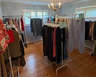 Ladies clothing including blue jeans, khakis, pants, skirts, shorts, dresses, tops, blouses, suits, wool coats, raincoats, purses, and tote bags. One rack of Talbots.