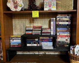 Berry wreaths, Christmas boxes, Christmas tins, VHS/DVD movies, Christmas cassettes and CDs, 2 record albums, 2025 calendars, basket of state maps