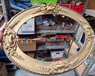 Oval gold wood frame.