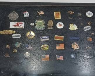 collection of old lapel or hat pins