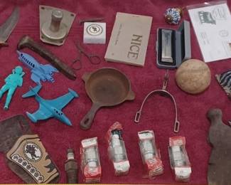 all on tray, cowboy spur, antique toy cap gun, vintage auto foot light dimmer switch, iron hatchet, old spark plugs, Hohner harmonica like new in case, old space ship toys, bone handle damascus blade hunting knife, Knights Templar paperweight, ww1 era Nice France postcard book, old cast iron egg skillet or ash tray, more