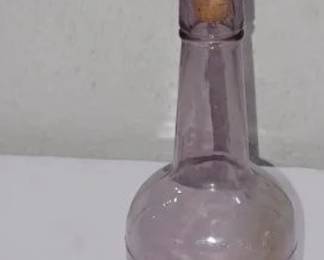 Sun purple circa 1910 whiskey bottle with animated carved wood cork, Jack Daniels label.