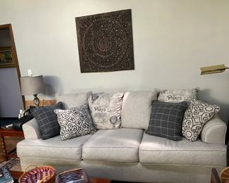 Couch and Hand Carved Wall Hanging