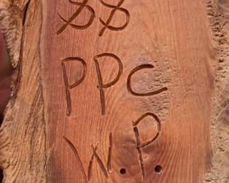 Signature on back of carved wood tree spirit -Oregon?