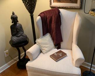 A vignette in the bedroom -pair of white wing back cahirs; 1 of 2 Buddhas; floor lamp