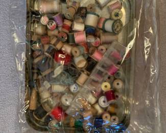 Large bin of wooden spools/thread