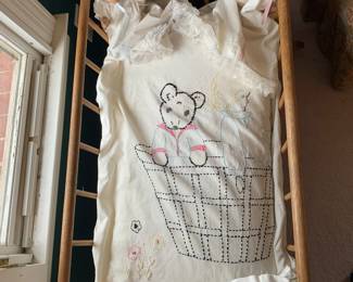 Baby cradle; embroidered sheet, dolls