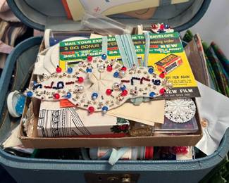 Case full of vintage craft items.