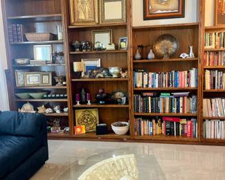 A library filled with art from around the world, books and home decor
