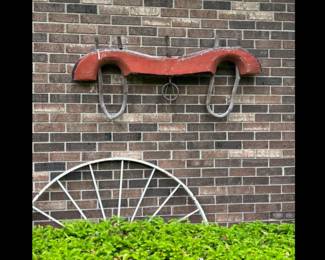 Antique wooden double ox yoke with red paint and iron hardware.
