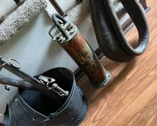 fireplace bellows, vintage metal and leather; leather collar and a fire suppression canister with handle.