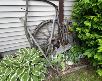 Rusty two-man crosscut saw with large teeth.
Old wooden plow yoke and farm implement parts, rustic patina.
Great for garden or farmhouse decor.