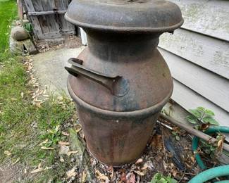 Large antique milk can with original lid and heavy rusted patina.