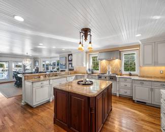 Base cabinets include a trash corral and a dishwasher